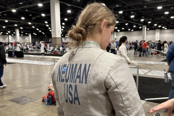 WHS junior Ella Neuman prepares for a fencing match at a tournament. “In a tournament, there's pools first, which is about five to six other people and you fence all of them to five touches,” Neuman said. 