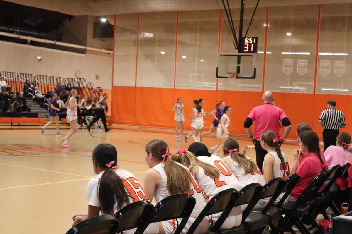 In honor of the annual Coaches vs Cancer, all players wore pink bows in their hair. In addition to the bows, the team wore matching pink shirts and spent time before the game setting up the gym with pink streamers and hearts.