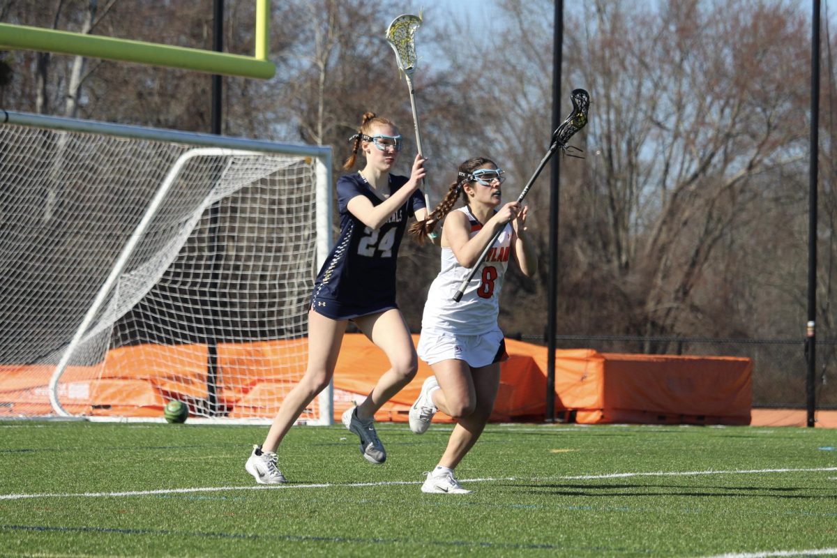 During a 2025 game, senior captain Sofia DiCarlo defends the ball from an Acton-Boxborough attacker. 