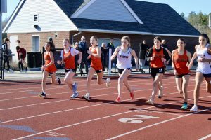 Competing to secure a spot in the beginning of the race, Wayland and Weston runners surge ahead at the start of the 800 meter race. 