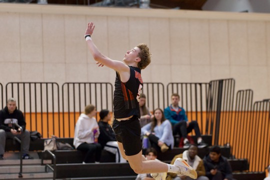Junior captain Finn Bell serves the ball during the second set of the game.