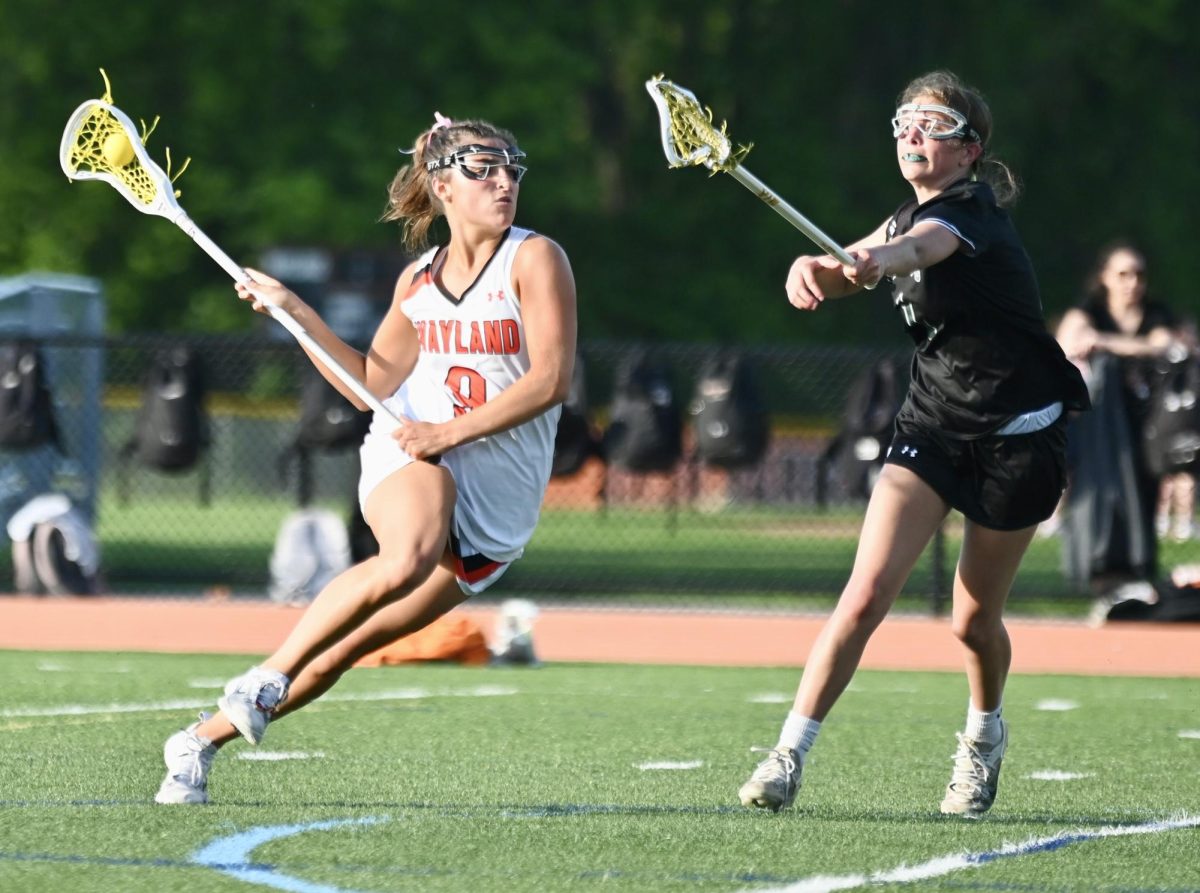 Swinging her arms, senior captain Jillian Mele shoots the ball into the goal. Mele scored six goals during the game.