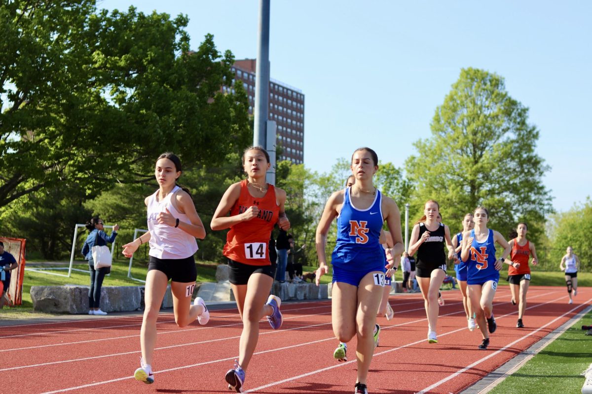 Running the 800 meter race, freshman Junyi Frenzel leads a pack of runners.  Frenzel got a PR with a 2:42.4, earning 13th place out of 19 runners. "I look forward to hopefully breaking 2:40 in the 800," Frenzel said.