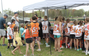 At this years "W Day," young lacrosse players gather around to meet professional lacrosse players who visited the fields on Sunday, May 4.