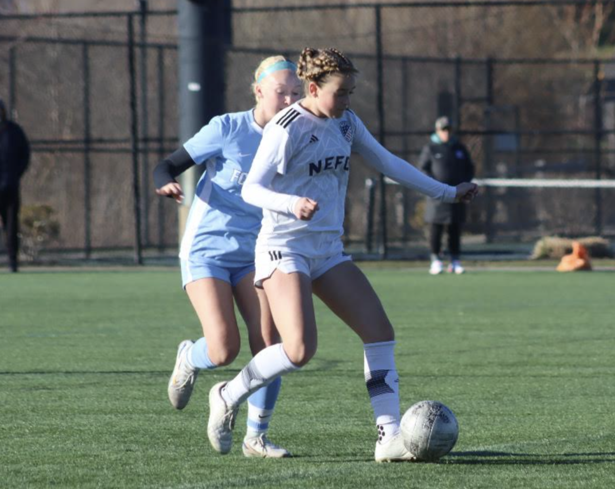 Freshman and New England Futbol Club (NEFC) soccer player Heather Maddocks kicks the ball down a turf field. New Englands Premier Soccer Club is one of many club sports teams. Club sports teams can benefit athletes greatly. However, some are very costly to families. 