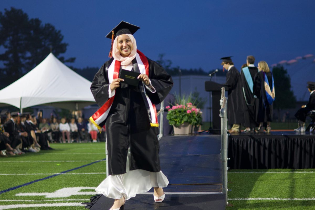 Smiling as she walks off the stage, senior Salma Dwidar celebrates graduating high school.