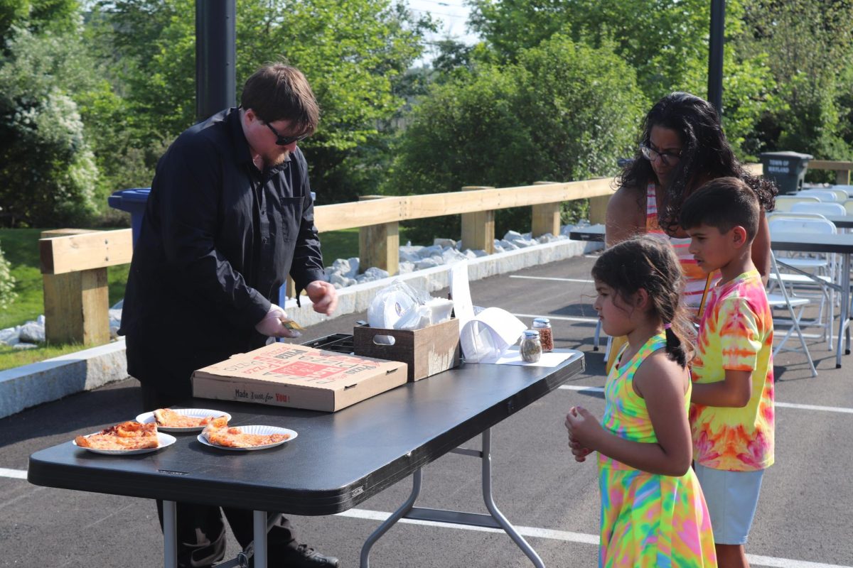 Giacomo's Ristorante sells cheese pizza to the attendees at the opening of the community center.