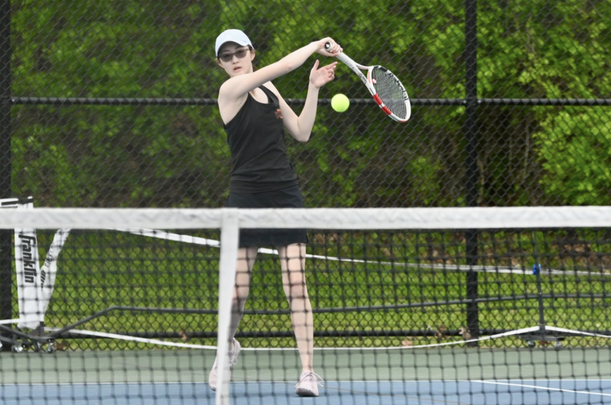 Freshman Elena Tan returns the ball across the court to her opponent. 