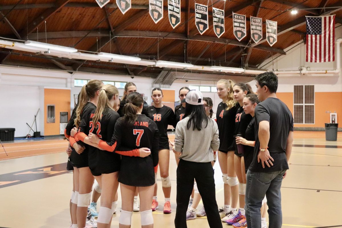 Huddling for a team meeting, varsity head coach Lisa Tsaur speaks to the players. Seniors Anna Yalli and Kalena Imura are the captains this year. "My favorite part of volleyball this year is the team," Imura said. "Many of us have played together before, which makes us really tight-knit."