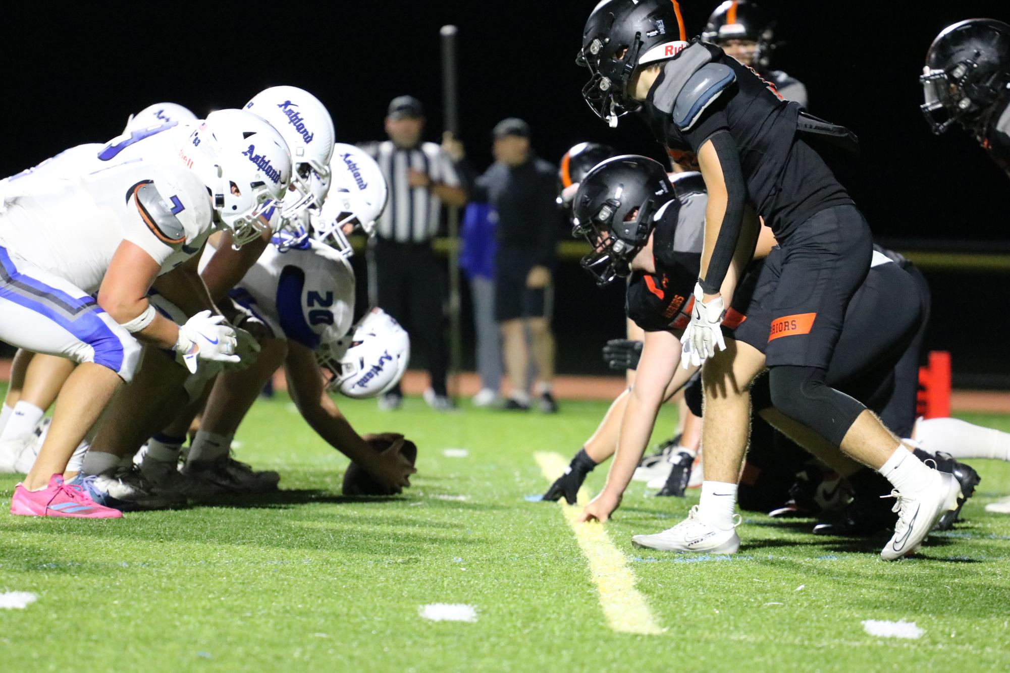 Wayland's defensive line sets up while waiting for Ashland to snap the ball and start the play. "I enjoy going out and playing my best with my teammates," sophomore Peter Papatoniadis said. "The chemistry of the team really brings us together on the field."