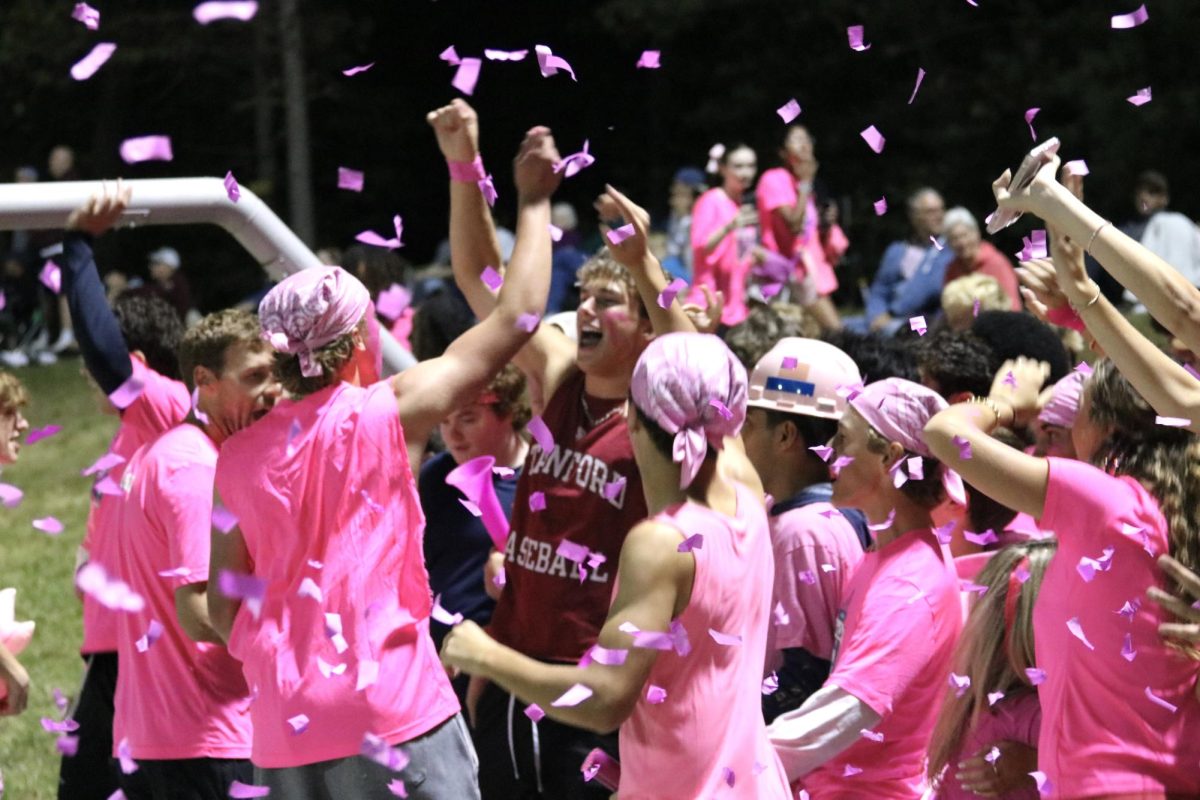 The Wayland student section cheers and pops confetti poppers following  Wayland's first goal of the game.