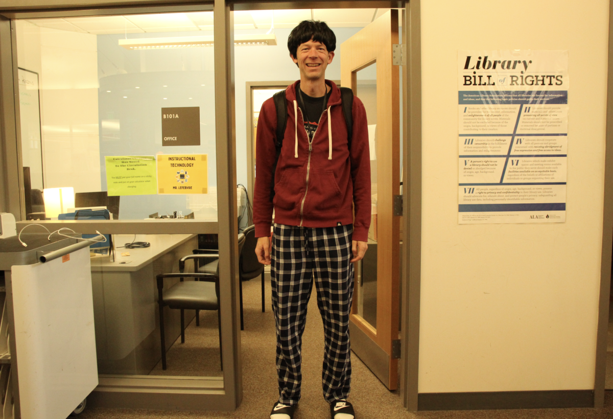 Instructional technology specialist Marc Lefebvre proudly shows off his costume as a typical high school boy. Lefebvre was inspired by the everyday attire of the students he's around each day.