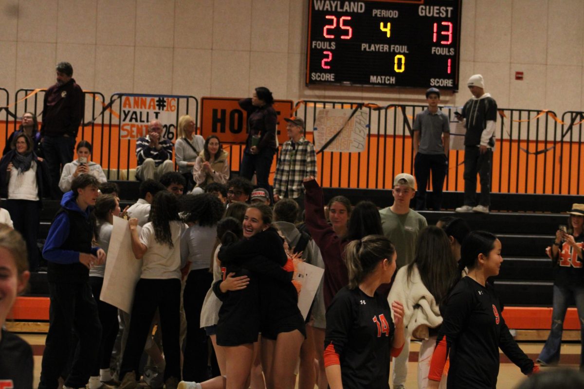 Friends and family run over, hugging the Wayland players after their big senior night win.