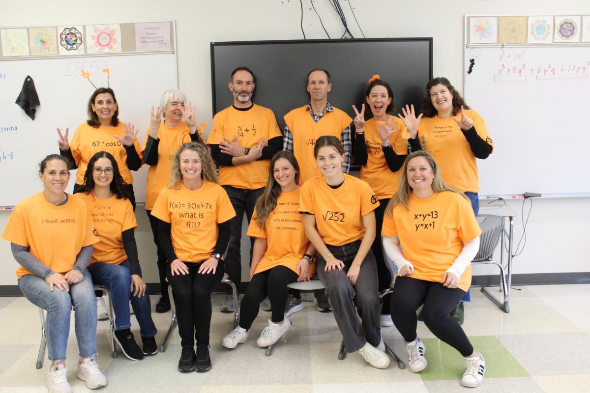 The math department wears matching orange shirts that had an equation that resulting to "six-seven," a current trend. 