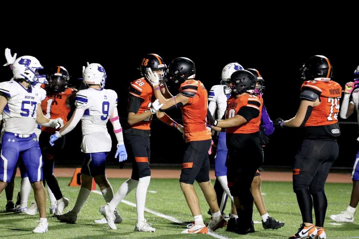 Sophomore Alex Pearlmen and senior captain Dylan Engelhardt celebrate after Pearlman scores his first of two touchdowns of the game. "I love seeing our underclassmen giving everything they got and proving themselves," Engelhardt said.