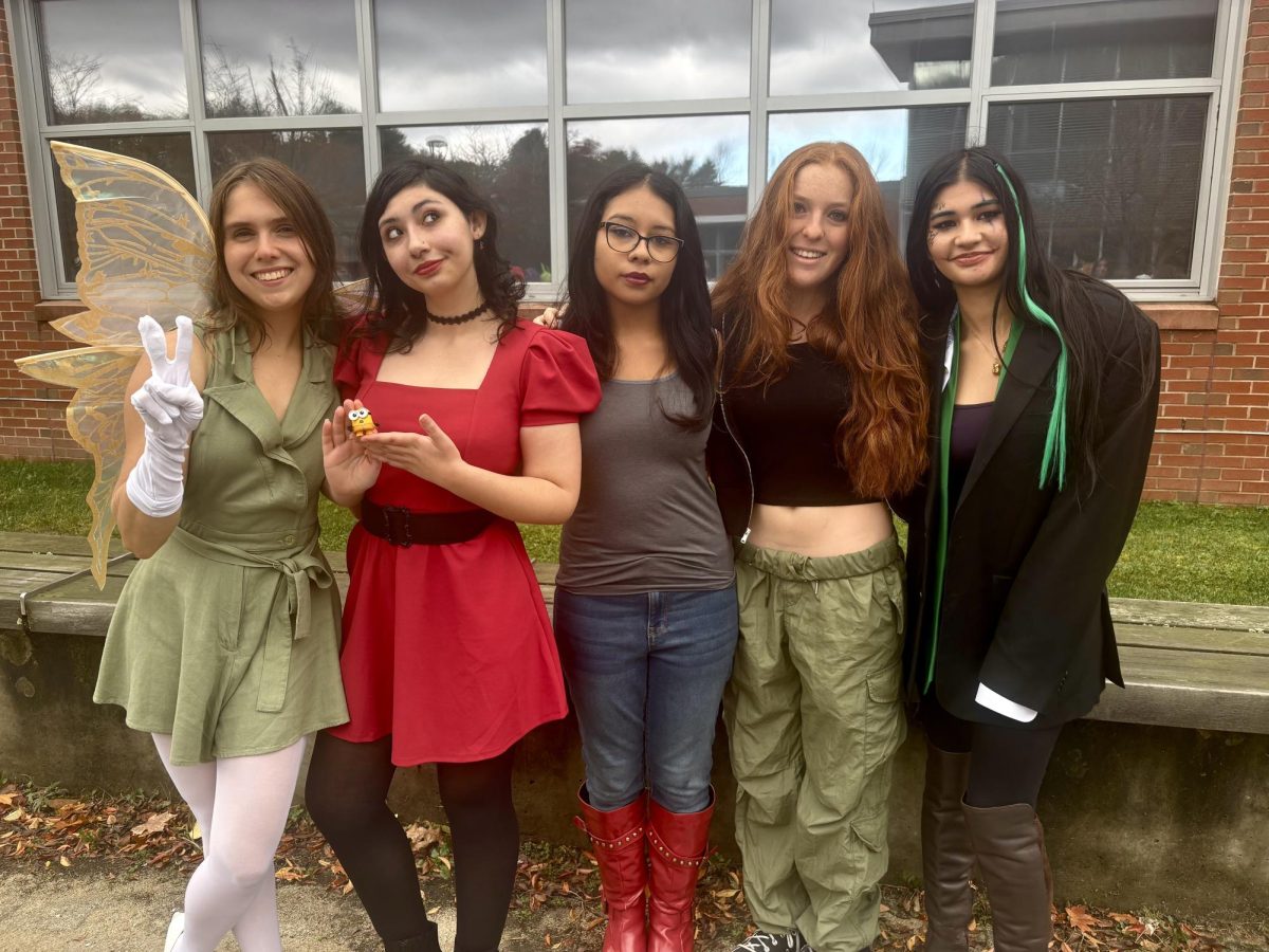 From left to right, seniors Vlada Sargsyan as Tinkerbell, Nicky Amaral as Scarlet Overkill, Jayda Ortega as Marceline, Marianna Rublev as Kim Possible and Manahil Faisal as the joker strike a pose in their costumes.