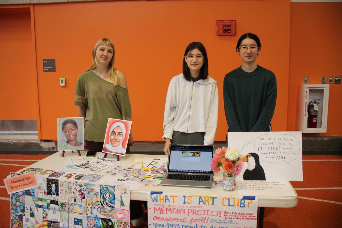 At the Art Club stand, co-leaders juniors Rachel Zhu, Evelyn Show, and senior Meadow Long smile at the camera. "You can be really creative here, and no one's going to judge you," Zhu said. Art club strives to create a creative and open environment for all WHS students."[Students] can just like work on whatever [they] want to work on," Jiang said. "Also [this club can be] for students who might not be taking any art classes."