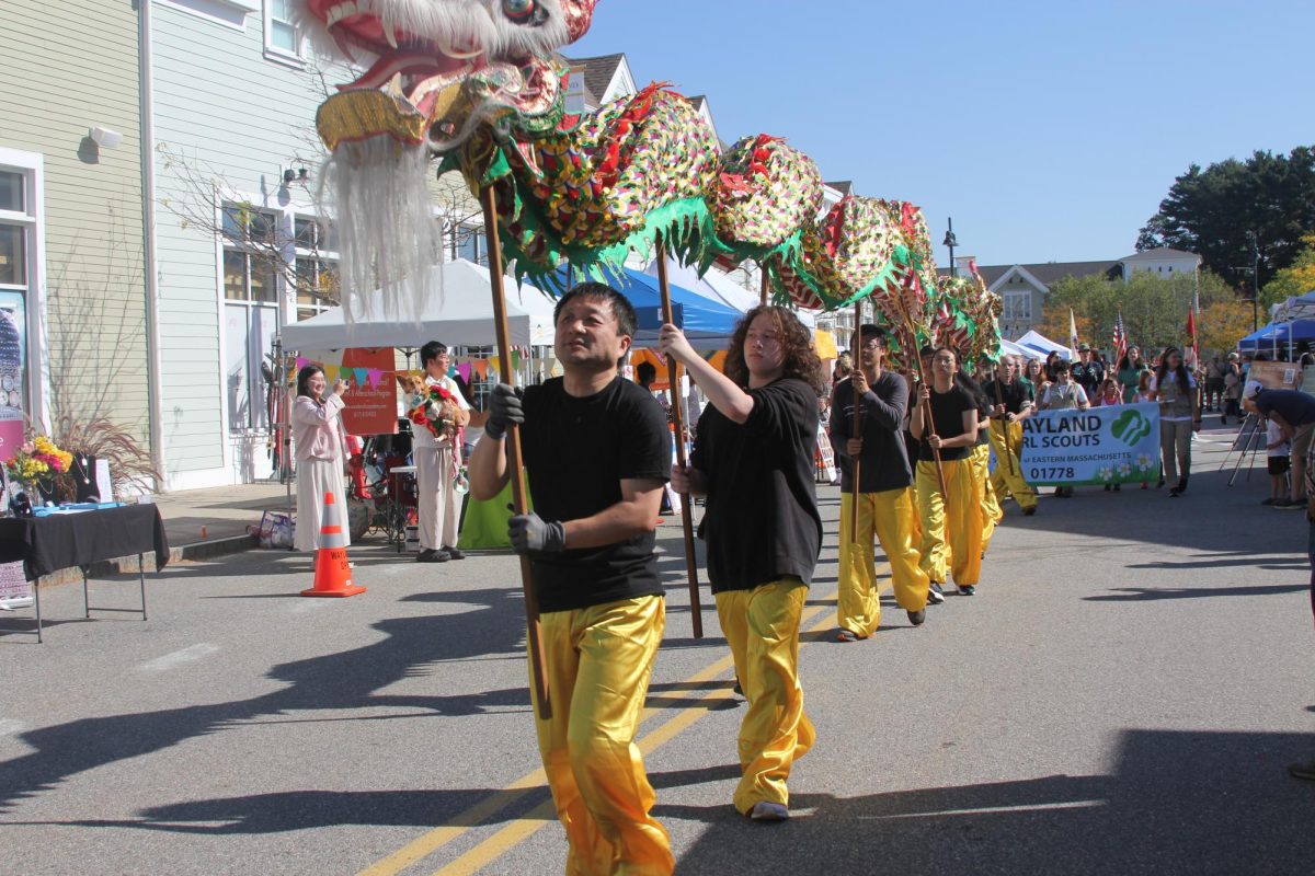 A group of volunteers perform the Dragon Dance, a ceremony usually performed during the Mid-Autumn Festival or Lunar New Year. They were one of the main attractions of the parade.