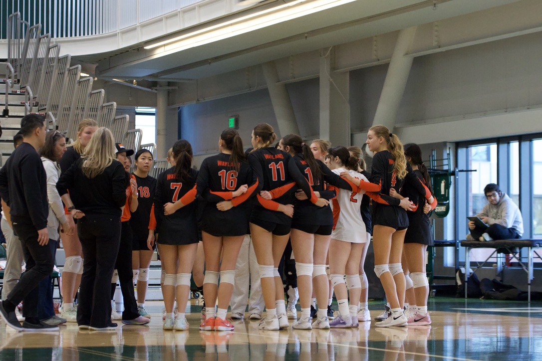 Huddling during a timeout, the team embraces each other as they listen to coach Lisa Tsaur. Timeouts are set to be one minute periods.