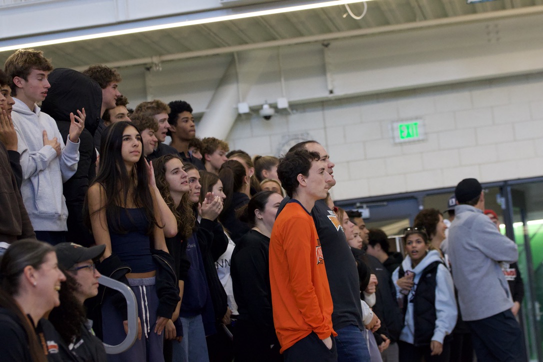Closely watching the team, student gather to support their classmates in the finals. Many students dressed in orange and black to show their spirit.