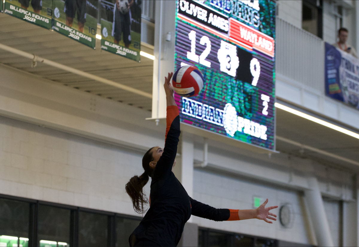 Eyeing the ball during a serve, senior captain Anna Yalli attempts to gain a point for her team. Yalli is a starting outside for the team.