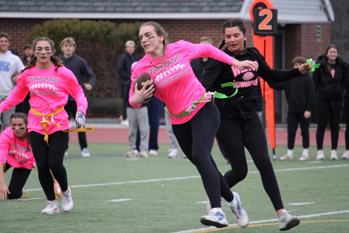 Senior Kelsey Kaufmann dodges a Weston defender with the ball in hand. Kaufmann played as the team's quarterback.