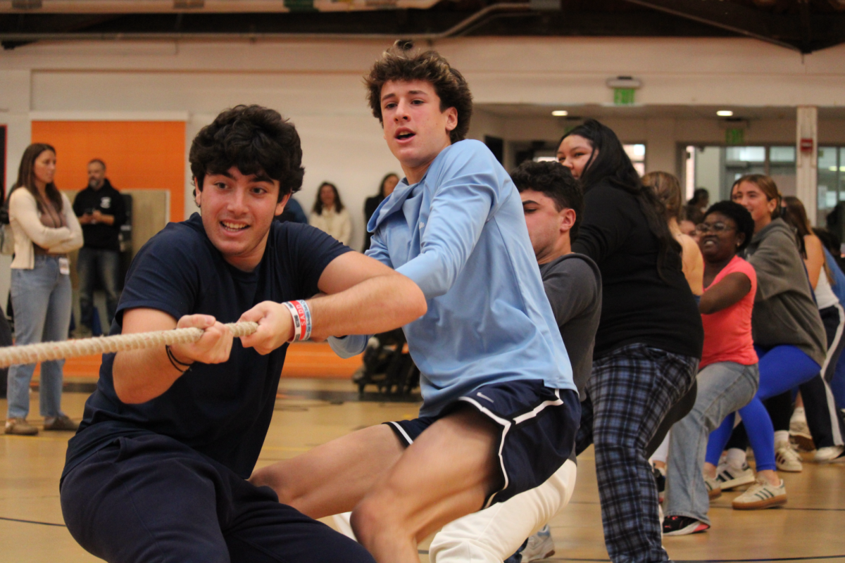 Sophomores George Bressler (front) and Alex Pearlman (back) pull hard on the rope during tug of war, the final activity of spirit day.