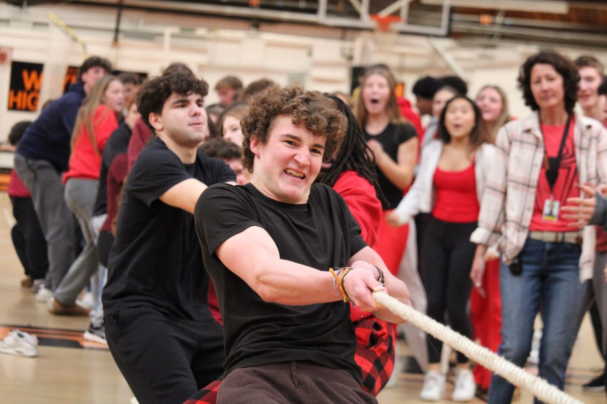 Juniors Luke Kroncke (front) and Josh Grossman (back) pull with the rope with grit in tug of war.