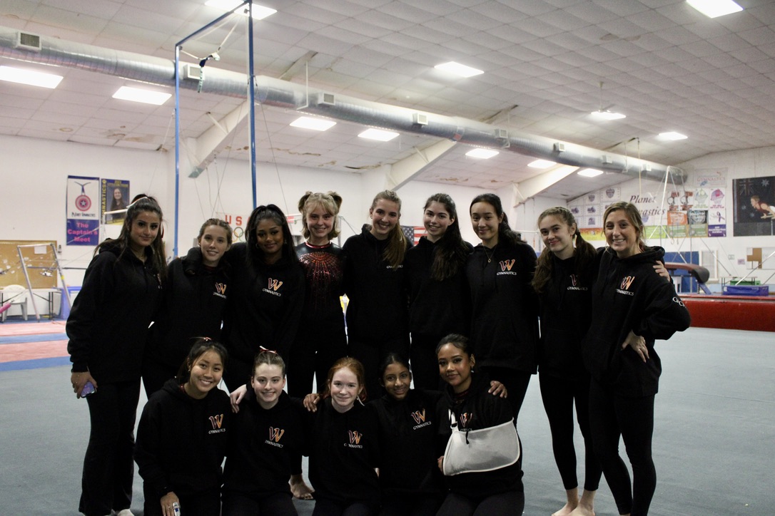 Members of the Wayland-Weston Gymnastics team smile during the first season of gymnastics. The team was created after years of interest from families in both Wayland and Weston. 