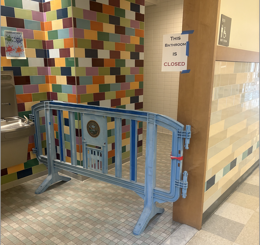A barricade blocks off the boys bathroom in language wing. A sign also hangs on the doorframe, closing off the bathroom.