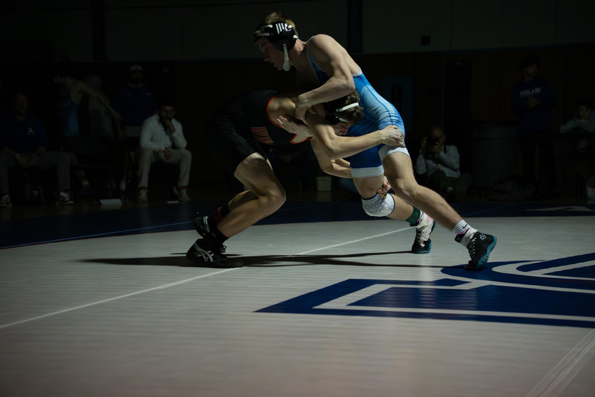 Senior captain Mark Altreuter of the 138-pound bout lunges forward and grasps an Ashland wrestler's legs.
