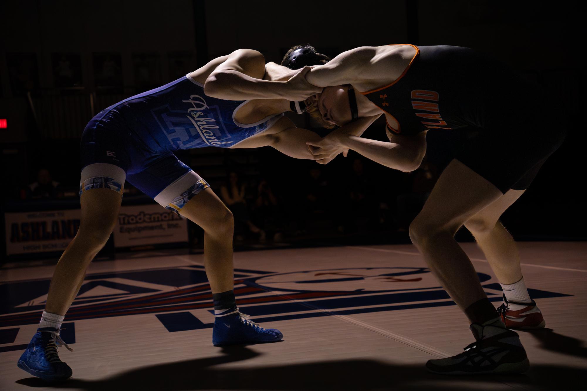 Senior Dan Florez of the 144-pound bout ties up with an Ashland wrestler.
