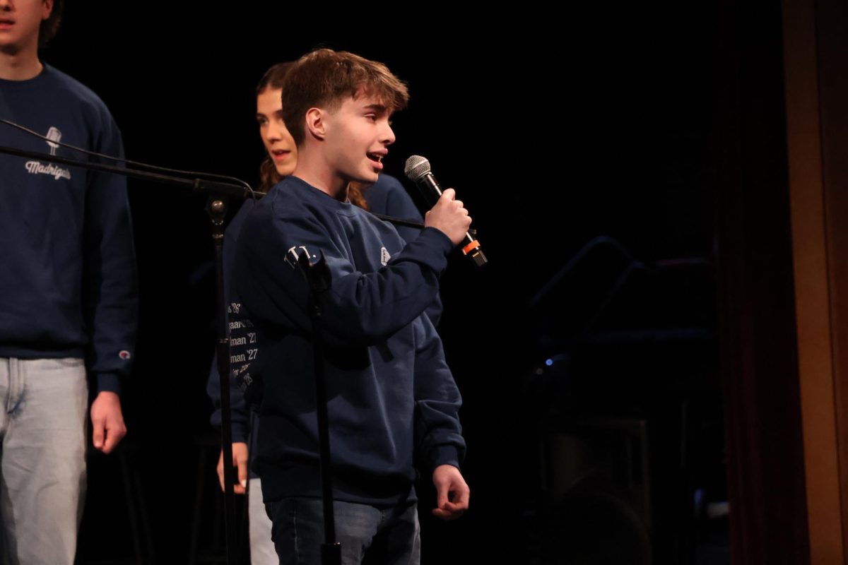 Senior Max Kuris sings out to the audience, soloing one the group's songs.