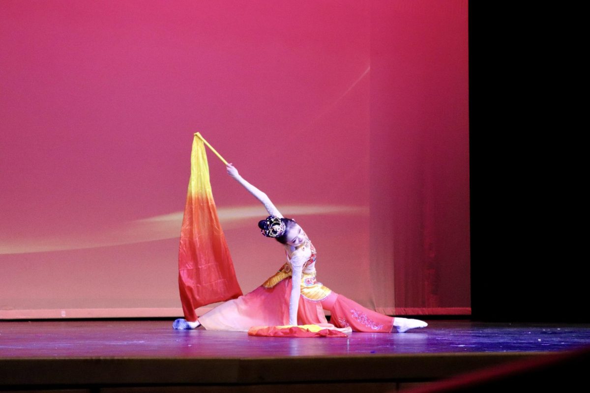 Artisan Dance Academy member Gemma Xu enters a dynamic pose as she performs a traditionally inspired Chinese dance. The dance was titled “Beneath the Eternal Moon.”