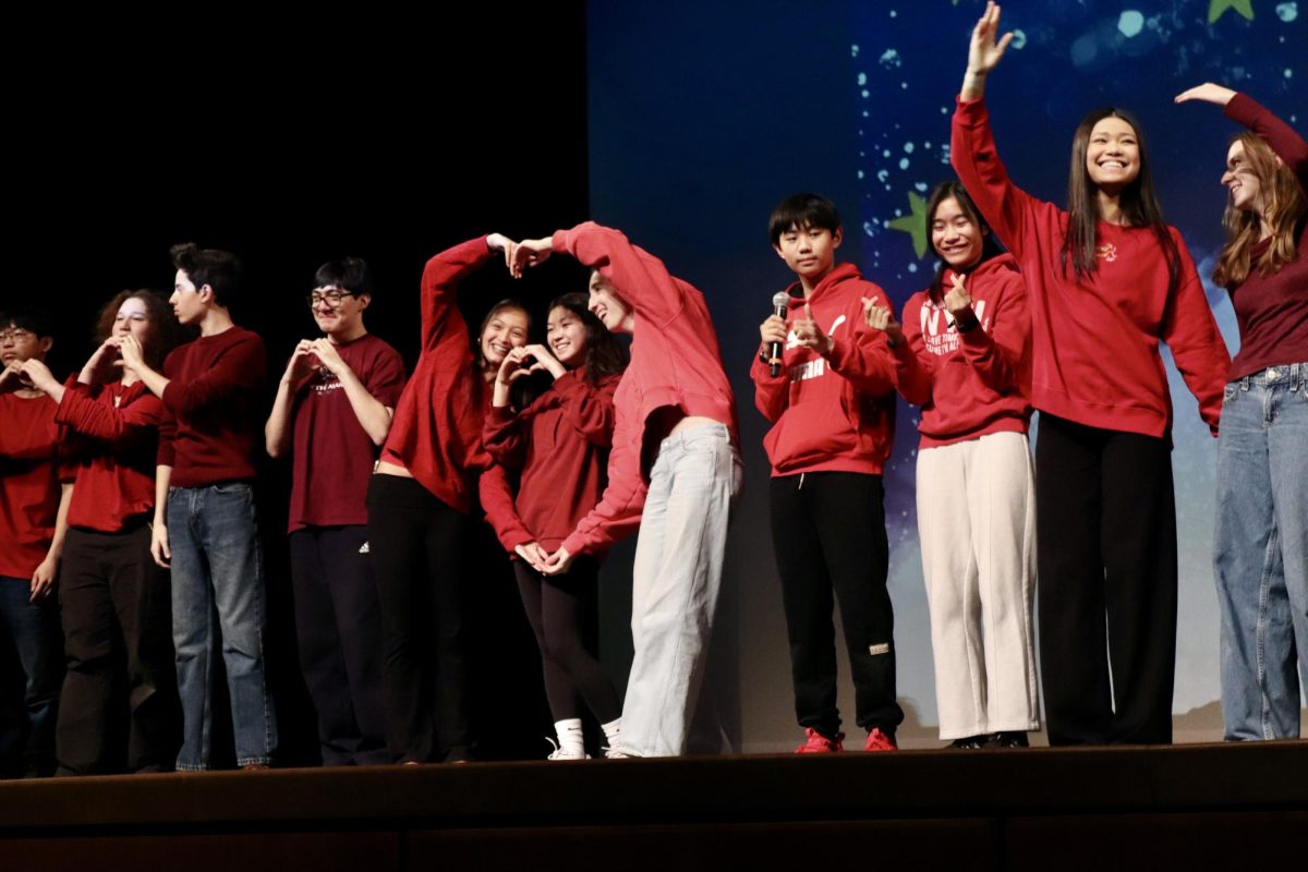 Students who take the Mandarin class offered at WHS make heart shapes with their bodies after singing “The Moon represents my Heart” by Teresa Teng.