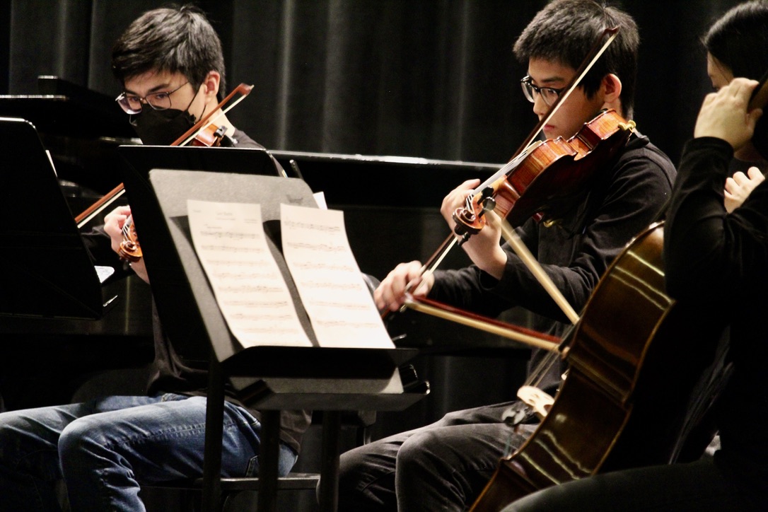 From left to right, Senior Sebastian Rideout and senior Jeffery Mao perform as part of a quintet.