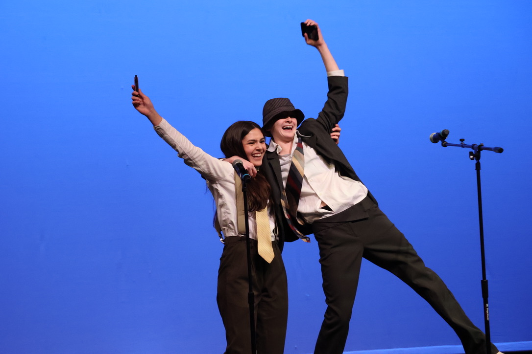 Juniors Breslyn Voight (left) and Sazie Wrentmore (right) celebrate following the completion of their performance. Voight and Wrentmore performed the popular song 'Piano Man,' by Billy Joel with both vocals and harmonicas, alternating with each other. Wrentmore said that the decision to perform in the talent show was impulsive, and also said that she had only learned harmonica 2 weeks prior. "I was sitting at a table with me and Breslyn, and it was honestly a very impulsive decision [to perform]," Wrentmore said.