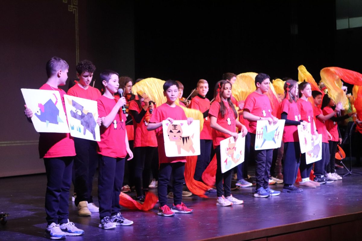 WMS students who take the Mandarin class hold up decorated animal signs in their performance of "Zodiac New Year's Greetings."