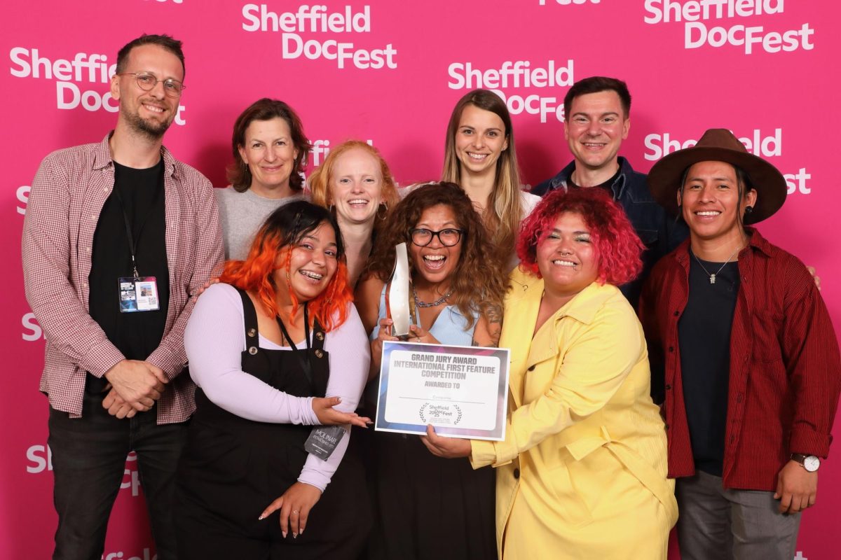 The “Comparsa” team accepts the Grand Jury Award at Sheffield DocFest on June 22, 2025. Back row, from left: ARTE France jury member Alexandre Marionneau, producers Olivia Ahnemann and Anna Hadingham, co-directors Vickie Curtis and Doug Anderson and cinematographer Edgar Tuy. Front row, from left: subject and co-producer Lupe Pérez, subject and impact producer Marta Chicoj García and subject and co-producer Lesli Canela Pérez.