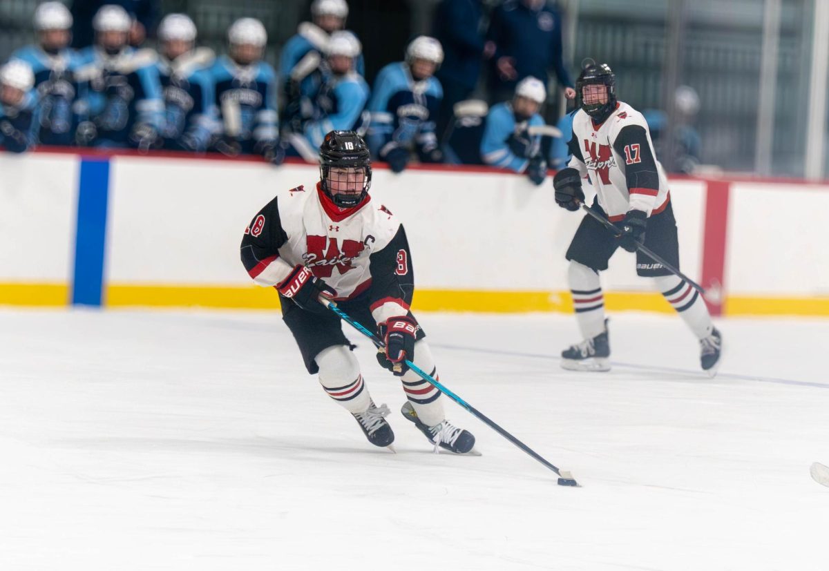 Watertown junior captain Luke Egan handles the puck and looks for an open teammate. Egan recorded two assists in the game.
