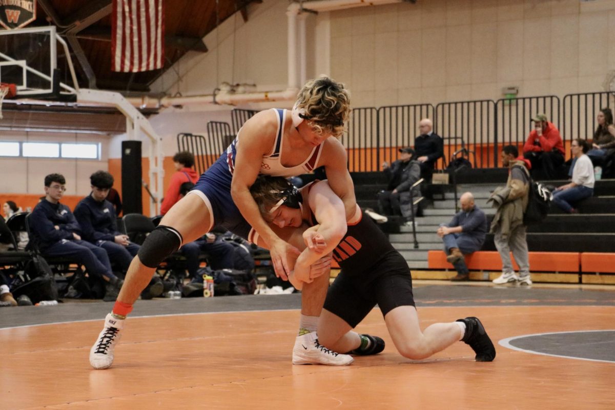 Grabbing a hold on a Belmont wrestler's leg, senior James Gallagher moves to his feet and lifts his opponent in the air before getting a take down, giving him three points in this match.
