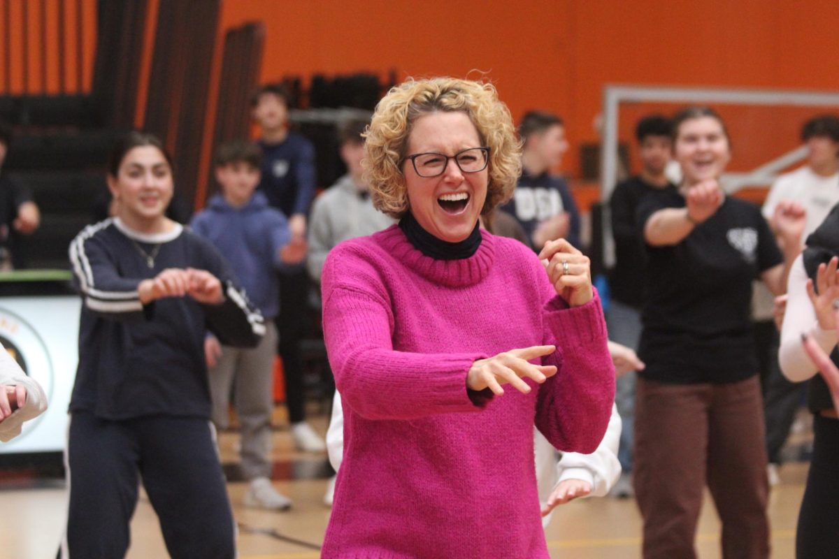 History teacher Erin Lehmann dances with a smile on her face. Lehmann teaches multiple senior classes, including Psychology and the Connect Program.