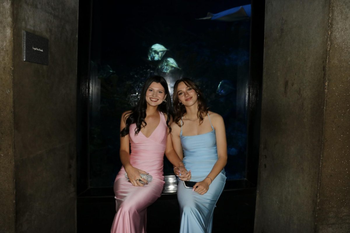 Sitting with the fish Junior Olivia Green (left) holds hands with her out of town date.