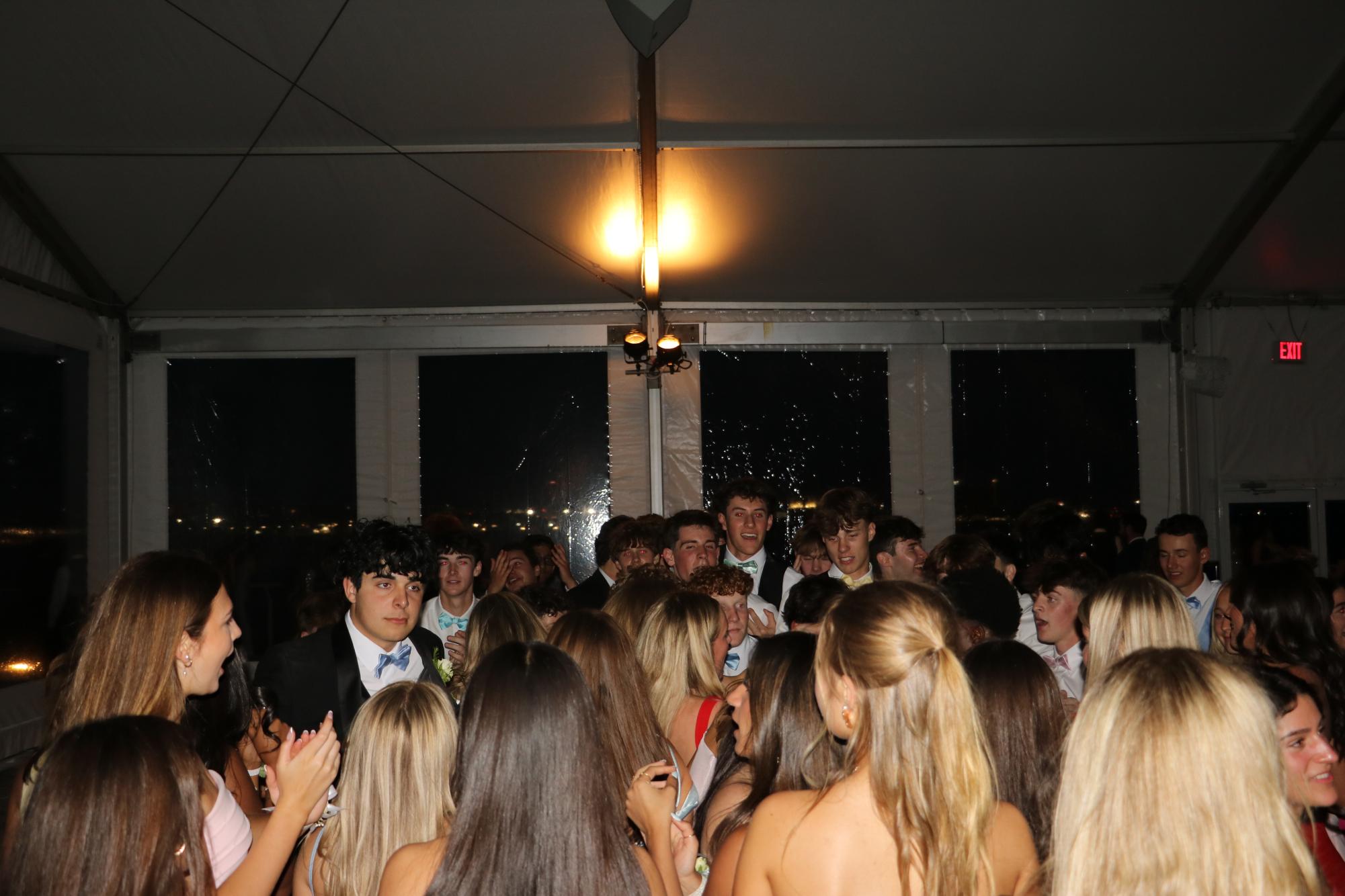 Students dance on the dance floor in the tent. The tent was located just outside the aquarium, offering views of Boston Harbor and the city.