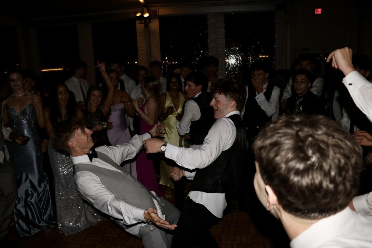 Juniors Josh Magyar (left) and Hayden Duffy (right) dance in a circle on the dance floor.