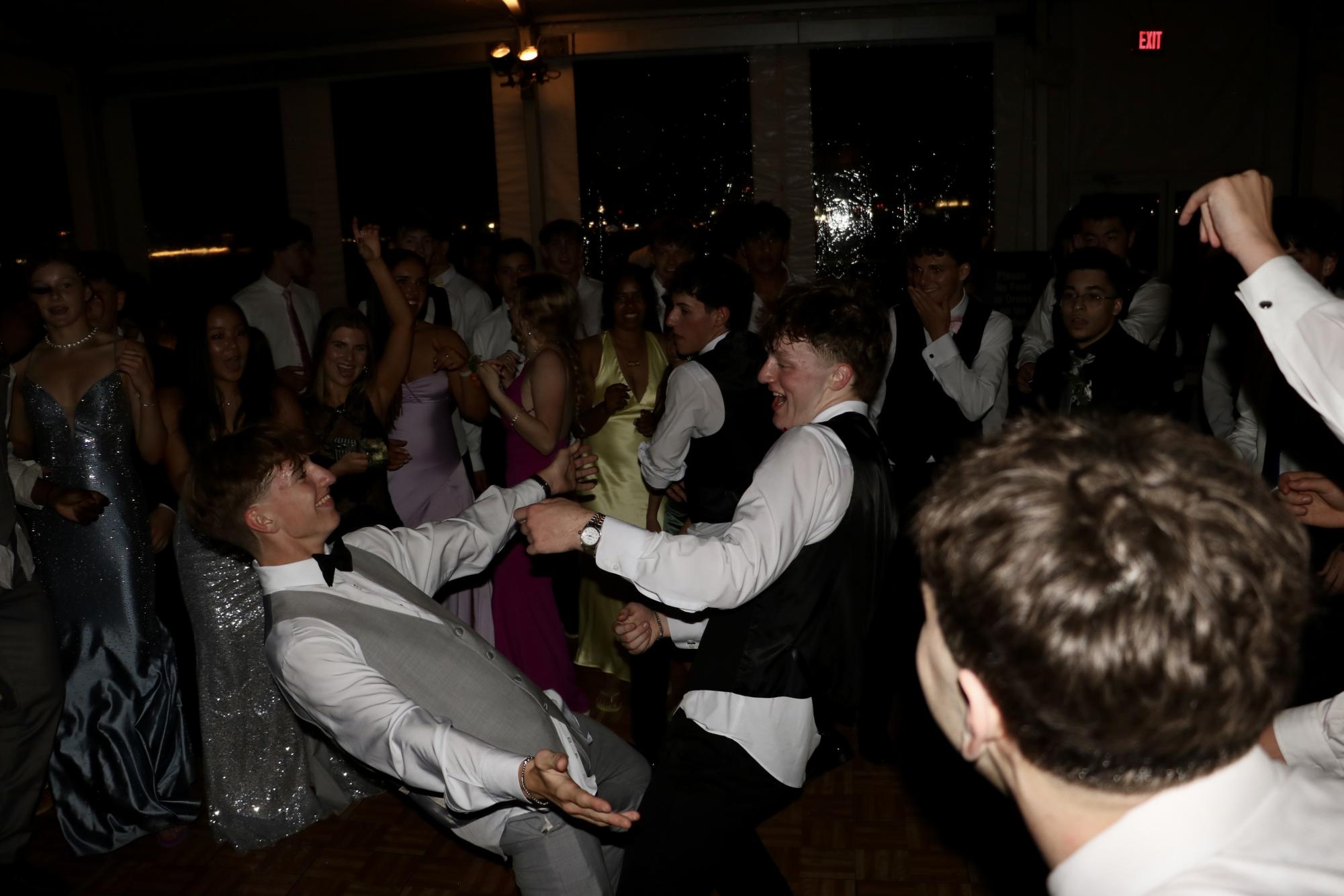 Juniors Josh Magyar (left) and Hayden Duffy (right) dance in a circle on the dance floor.